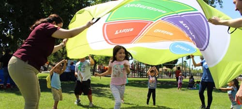 Image of kids running under a MyPlate blanket