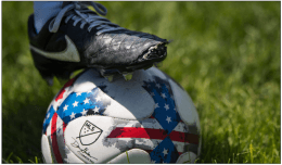 Image of soccer cleats on soccer ball